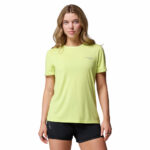 a woman wearing a yellow endless trail running tech tee