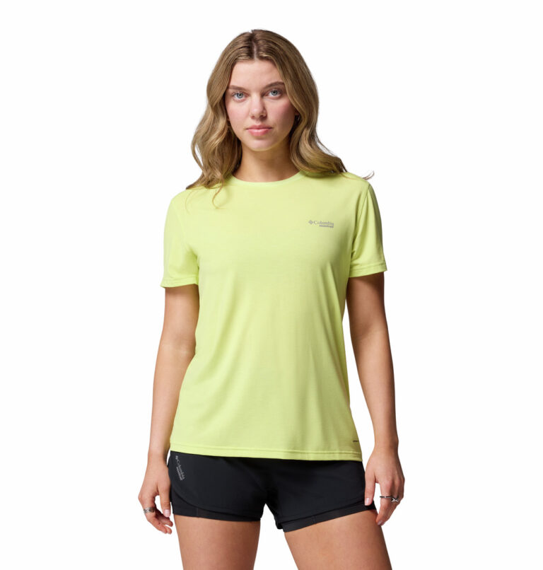 a woman wearing a yellow endless trail running tech tee