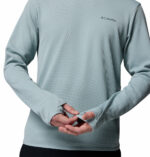 a man wearing a blue tech trail utility warm long sleeve crew shirt