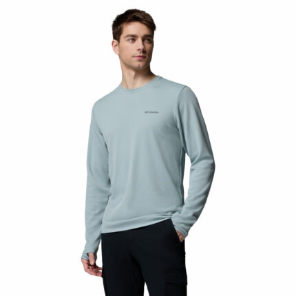 a man wearing a blue tech trail utility warm long sleeve crew shirt