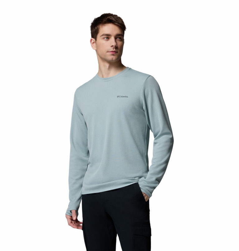 a man wearing a blue tech trail utility warm long sleeve crew shirt