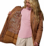 a women wearing a brown Suttle Mountain Long Insulated Jacket
