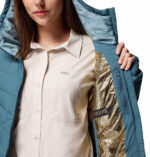 a women wearing a blue Joy Peak II Hooded Jacket