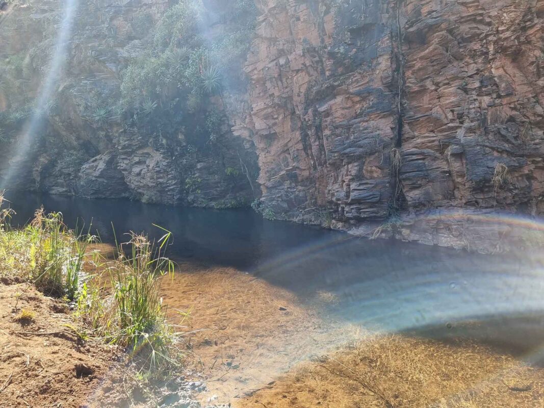 Serene water surrounded by rocky cliffs
