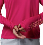 a women wearing a pink PFG Tidal Tee II Hoodie