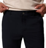 a man wearing a black ROC Tech Chino Pants