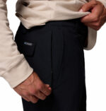 a man wearing a black ROC Tech Chino Pants