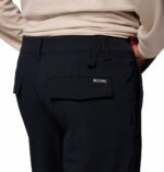 a man wearing a black ROC Tech Chino Pants