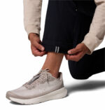 a man wearing a black ROC Tech Chino Pants