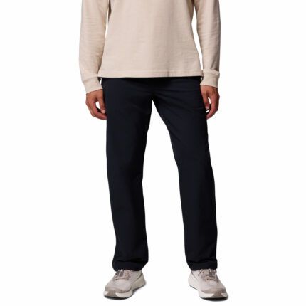 a man wearing a black ROC Tech Chino Pants