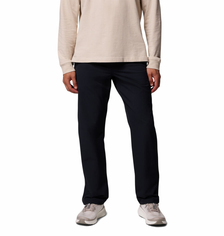 a man wearing a black ROC Tech Chino Pants