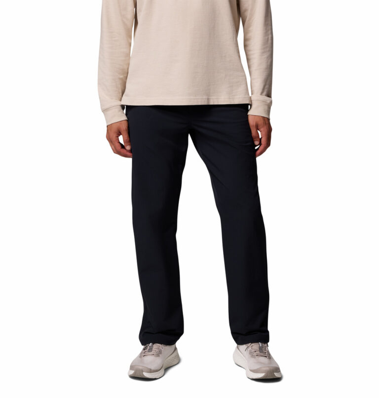 a man wearing a black ROC Tech Chino Pants