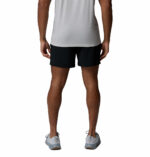 a man wearing a Terminal Roamer Stretch Shorts