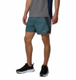 a man wearing a blue three pitch shorts