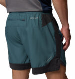 a man wearing a blue three pitch shorts