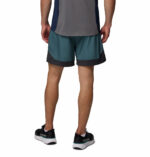 a man wearing a blue three pitch shorts
