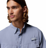 a man wearing a purple Skiff Guide II Short Sleeve Shirt