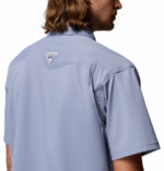 a man wearing a purple Skiff Guide II Short Sleeve Shirt