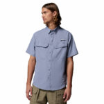 a man wearing a purple Skiff Guide II Short Sleeve Shirt