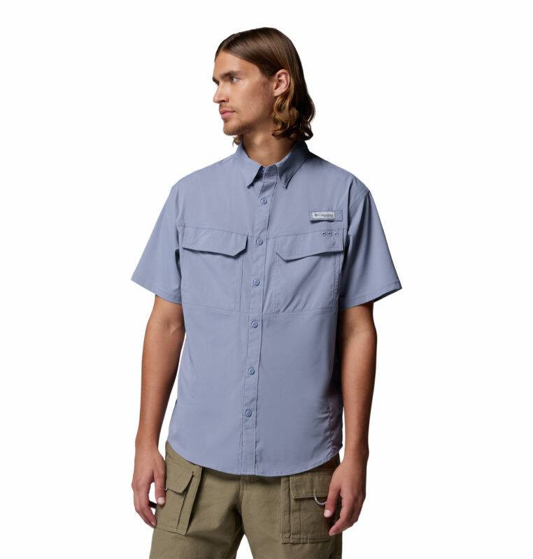 a man wearing a purple Skiff Guide II Short Sleeve Shirt
