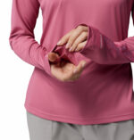 a women wearing a PFG Tidal Tee II Hoodie