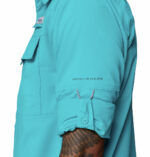 a man wearing a Skiff Guide II Long Sleeve Shirt