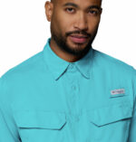 a man wearing a Skiff Guide II Long Sleeve Shirt