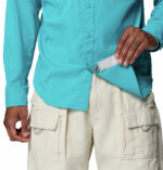 a man wearing a Skiff Guide II Long Sleeve Shirt