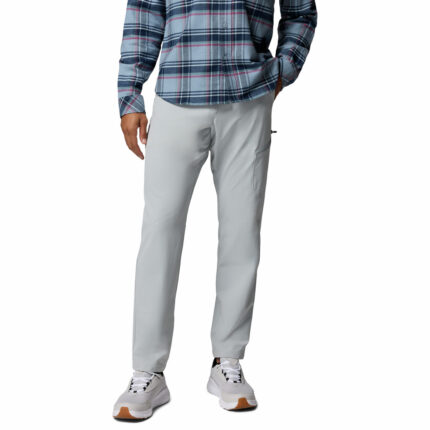 a man wearing PFG Breakline Pants